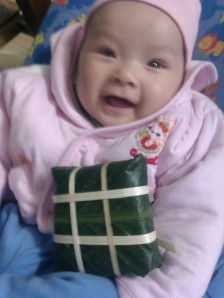 Labeled banh chung, but a baby fills most of the frame